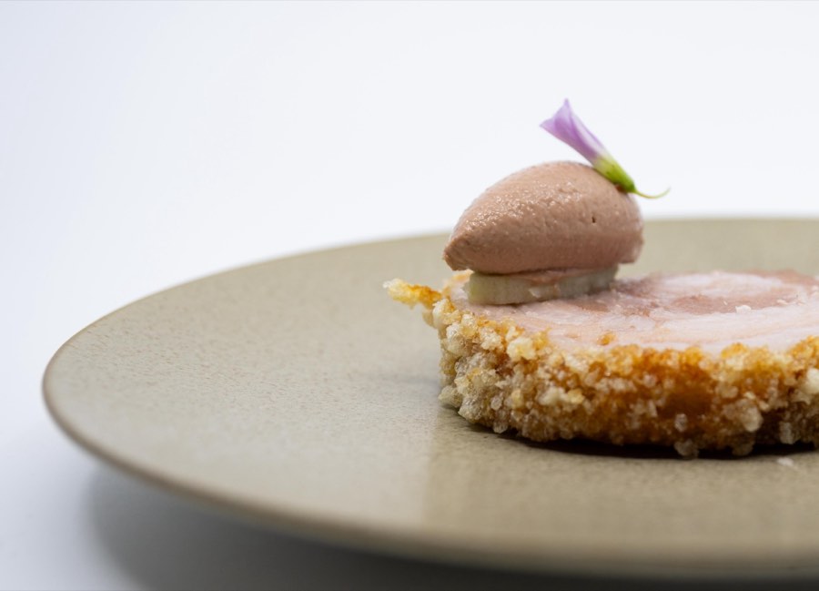 Lechon: crisp rolled pork belly with a quenelle of foie and a violet flower
