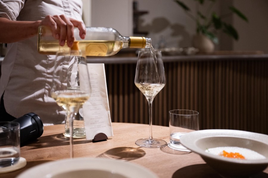 White wine being poured at the table